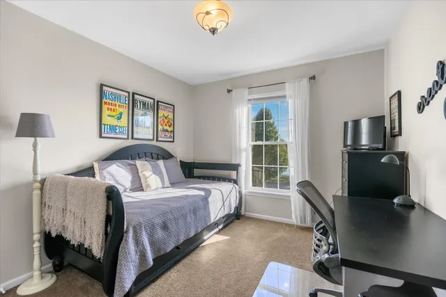 a bedroom with a bed and a desk