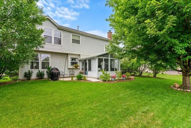 a front view of house with yard and green space