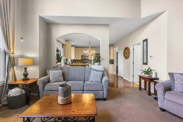 a living room with furniture and a lamp