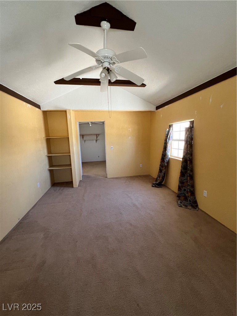 2151 West Simkins Road Pahrump, NV 89060 - Photo 21 of 23 Empty room featuring lofted ceiling, light colored carpet, ornamental molding, and ceiling fan