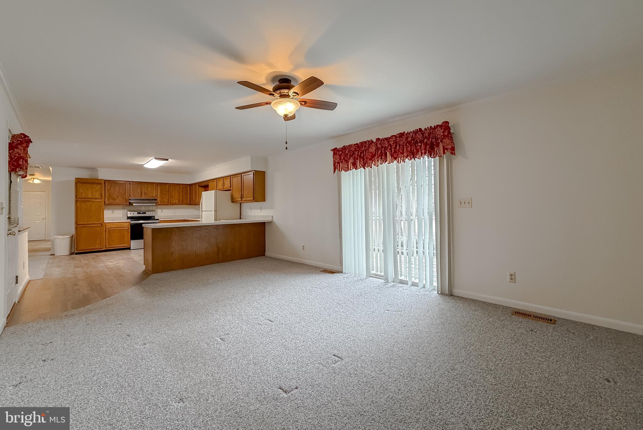 7615 Mill Creek Road Benedict, MD 20612 - Photo 14 of 37 a view of an empty room with a kitchen