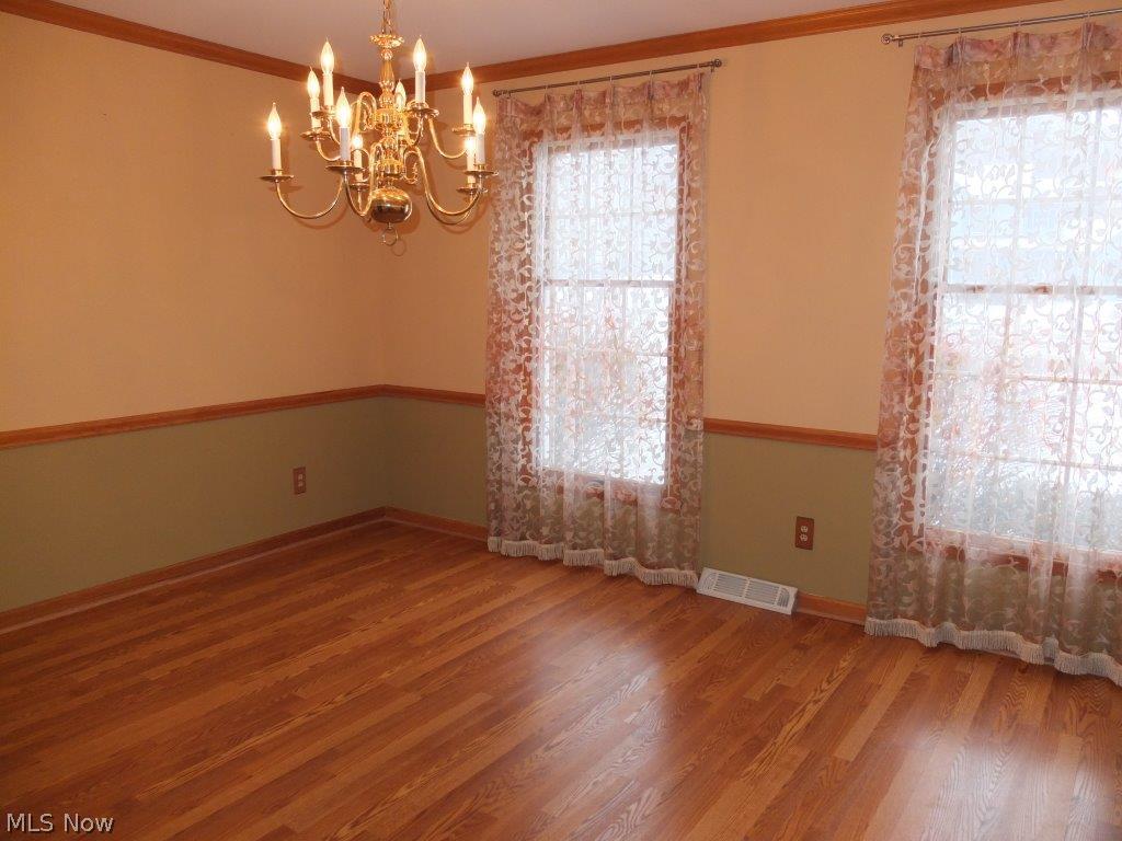 6301 Andalor Street Northwest Canton, OH 44708 - Photo 8 of 24 Formal dining room with crown molding and chair rail.