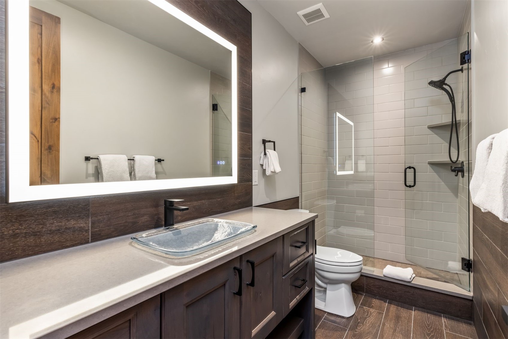 99 Independence Lane Keystone, CO 80435 - Photo 43 of 50 a bathroom with a granite countertop sink a toilet a mirror and shower