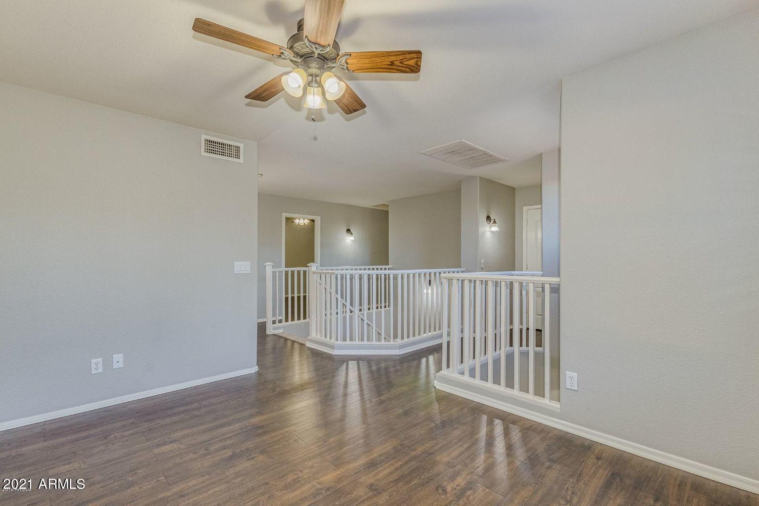 1791 East Del Rio Street Gilbert, AZ 85295 - Photo 12 of 28 an empty room with wooden floor fan and windows