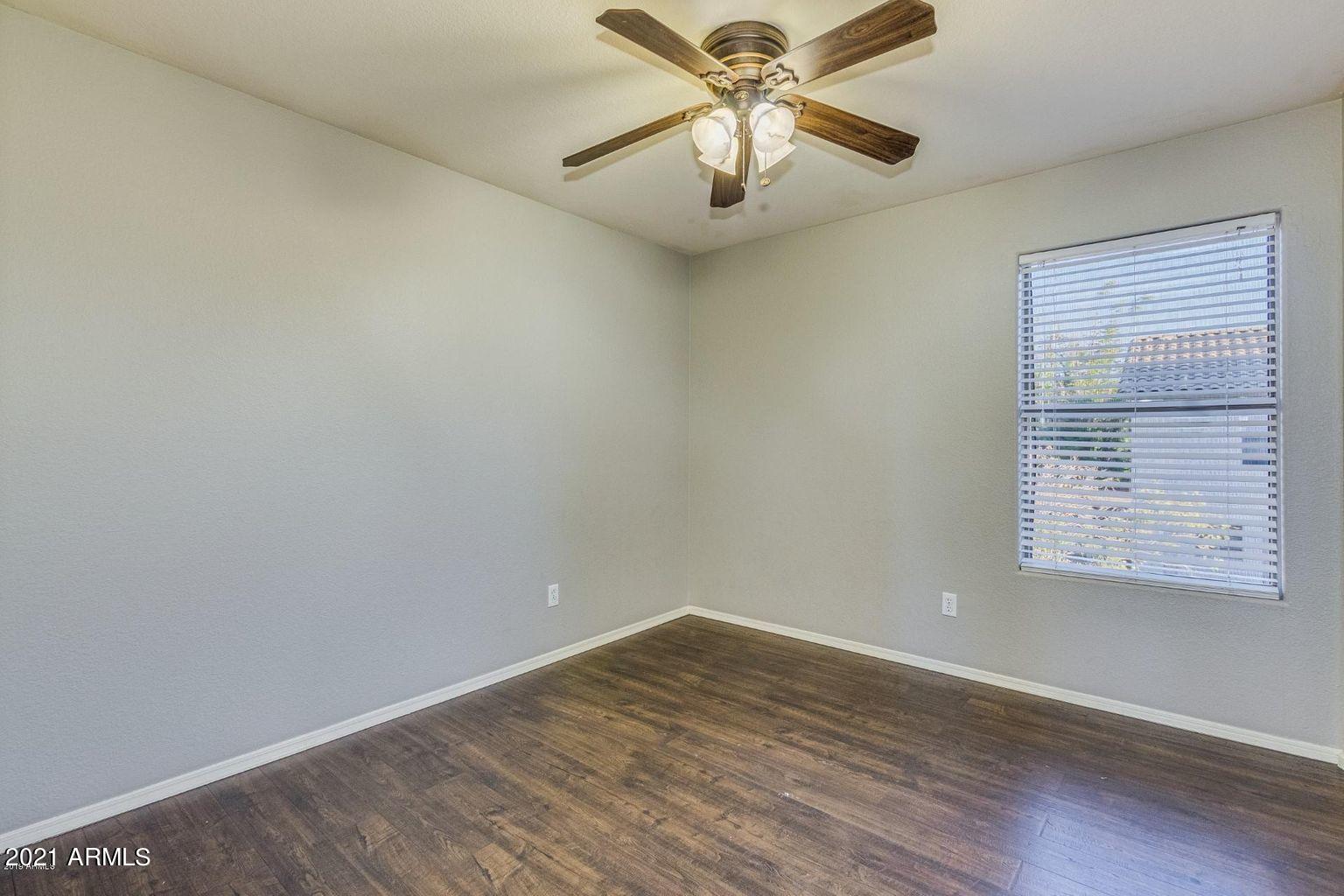 1791 East Del Rio Street Gilbert, AZ 85295 - Photo 16 of 28 an empty room with wooden floor fan and windows
