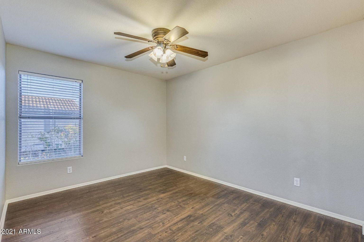 1791 East Del Rio Street Gilbert, AZ 85295 - Photo 18 of 28 an empty room with wooden floor fan and windows