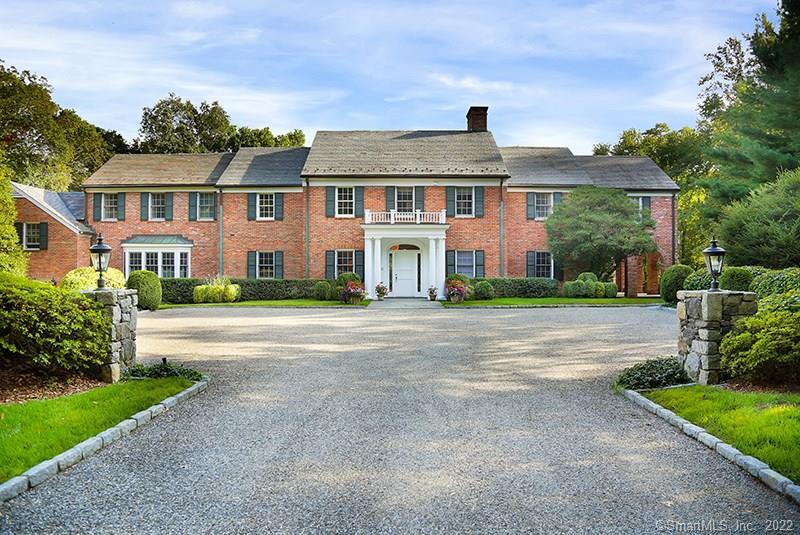 85 Round Hill Road Greenwich, CT 06831 - Photo 1 of 1 a front view of a house with a yard and trees