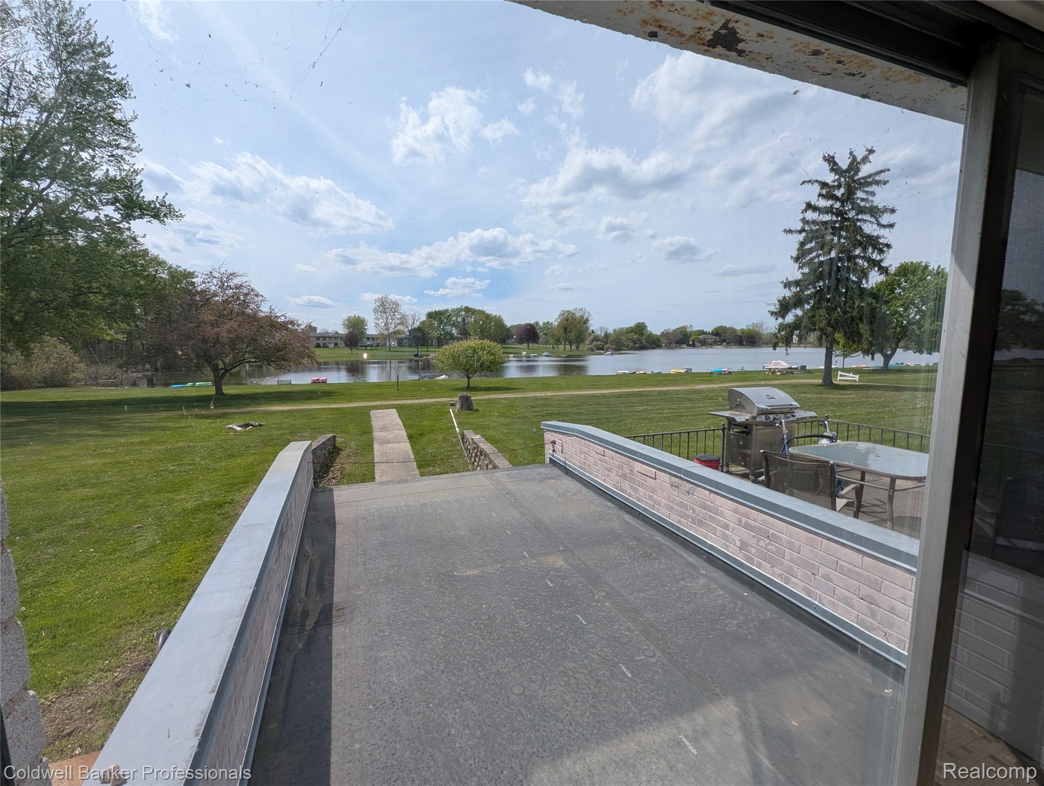 26945 Milford Road, Unit 8 New Hudson, MI 48165 - Photo 26 of 31 View of patio / terrace featuring a water view and area for grilling