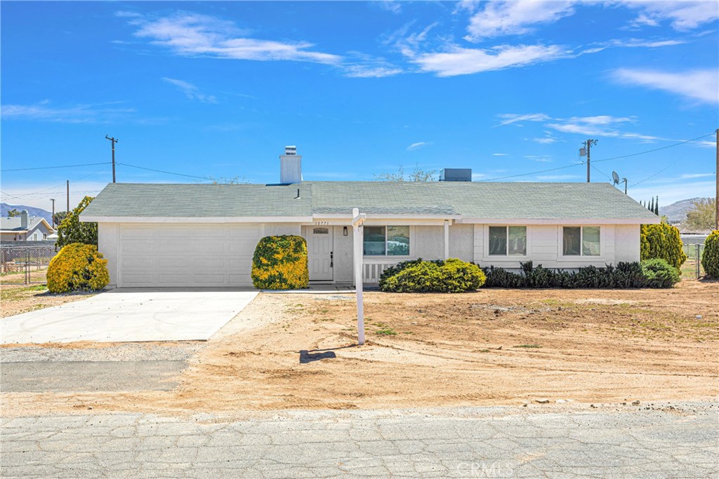 10771 Pinole Road Apple Valley, CA 92308 - Photo 1 of 1 a front view of a house with a yard