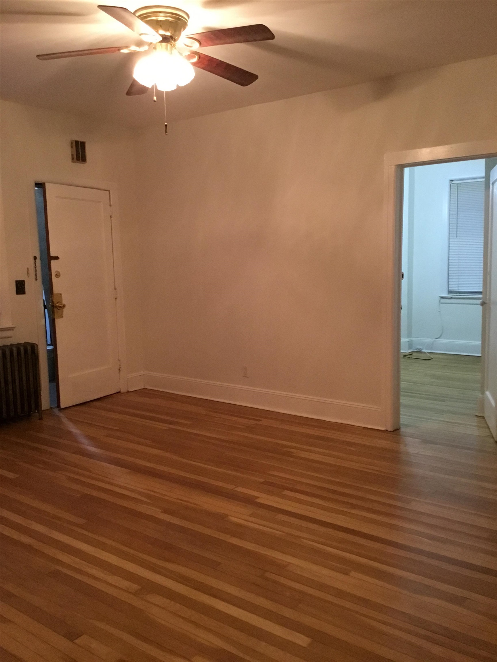 1407 70th Street, Unit 2 North Bergen, NJ 07047 - Photo 11 of 22 a view of an empty room with wooden floor