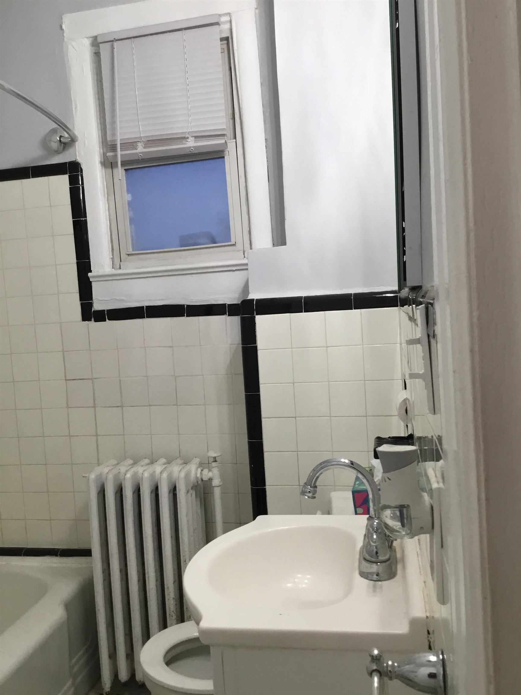 1407 70th Street, Unit 2 North Bergen, NJ 07047 - Photo 19 of 22 a bathroom with a sink and mirror