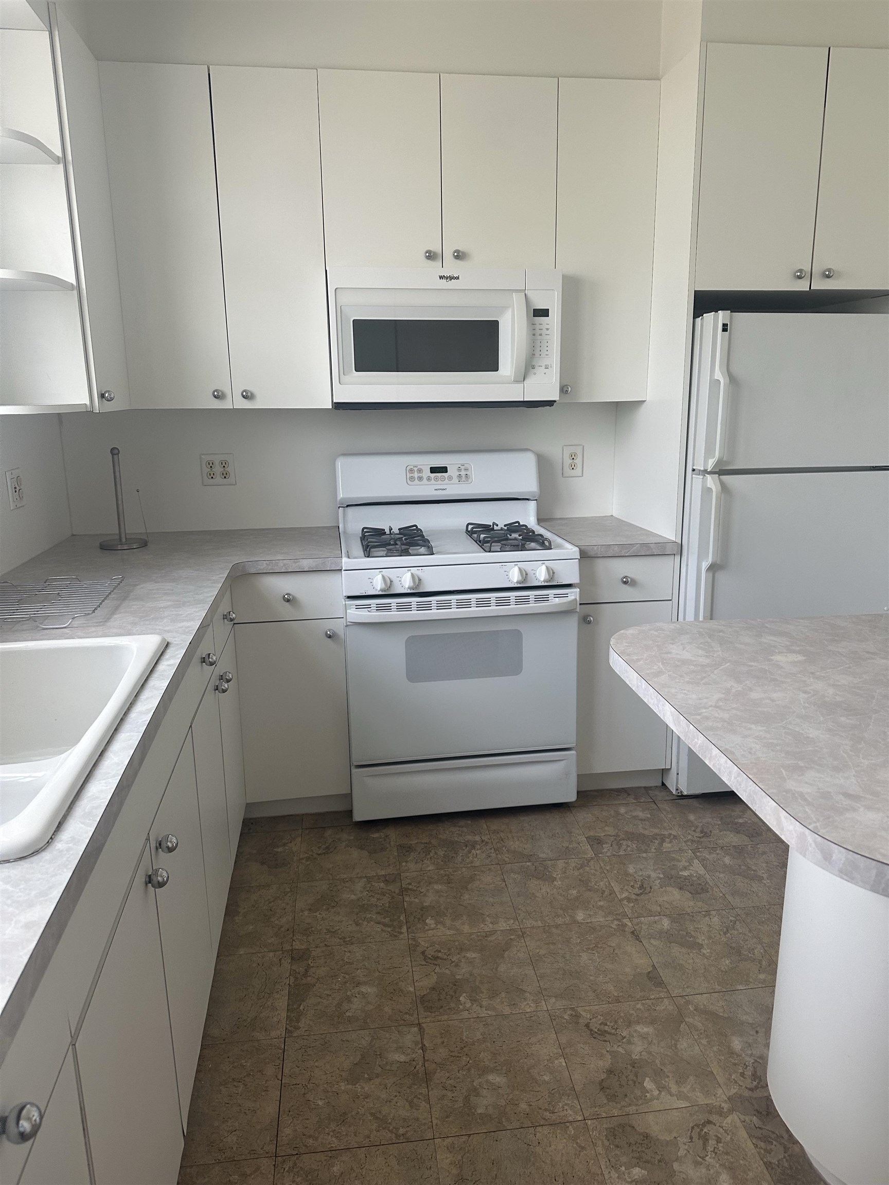 1407 70th Street, Unit 2 North Bergen, NJ 07047 - Photo 5 of 22 a kitchen with stainless steel appliances granite countertop a sink a stove and a refrigerator