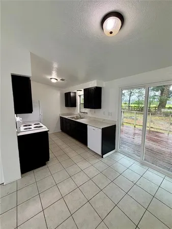 a kitchen with stainless steel appliances a stove top oven and a refrigerator