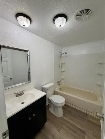 a bathroom with a sink toilet a mirror and shower