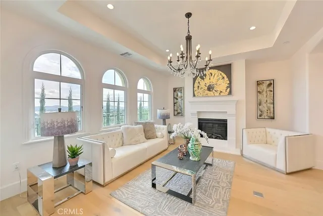 a living room with furniture chandelier and a chandelier