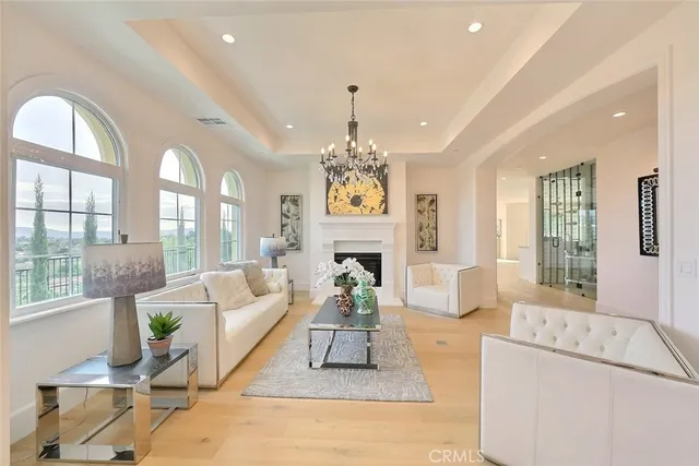 a living room with fireplace furniture and a chandelier