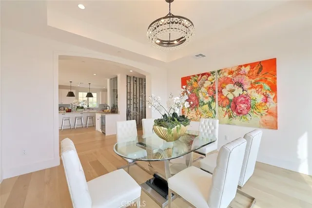 a view of a dining room with furniture wooden floor and chandelier