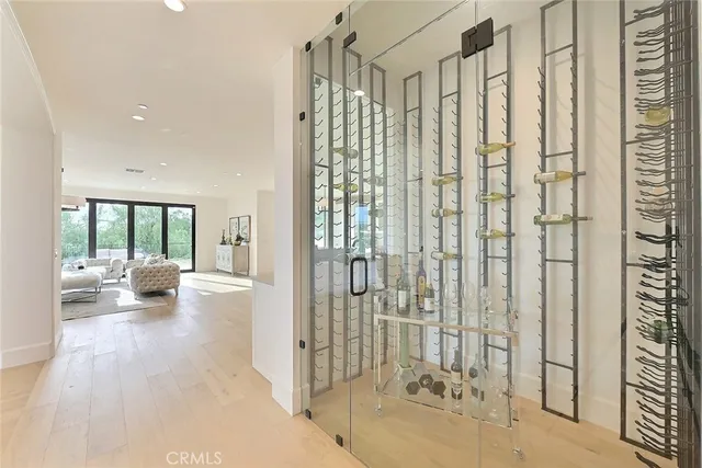 a open kitchen with stainless steel appliances granite countertop a stove a sink a dining table and chairs with white cabinets