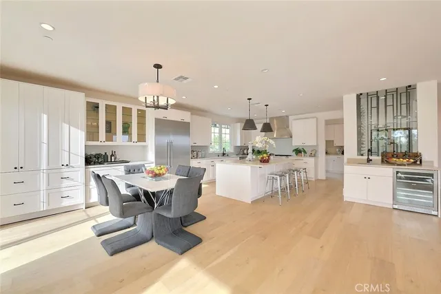 a kitchen with stainless steel appliances a stove a table a chair and a window