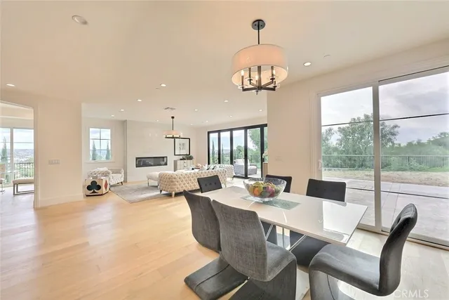 a kitchen with white cabinets and potted plant
