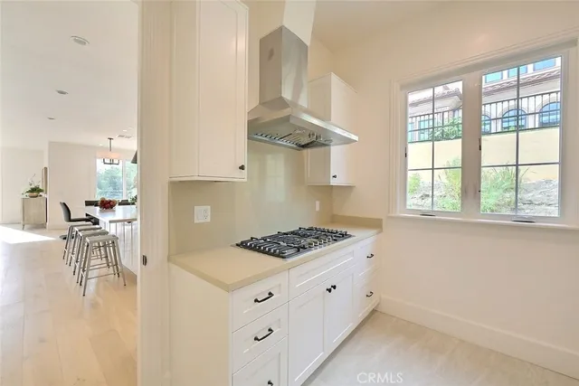 a living room with furniture chandelier and a large window
