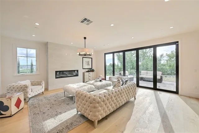 a bedroom with a bed a chandelier and a window