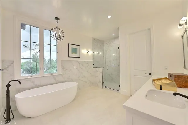 a bathroom with a tub a sink and a shower