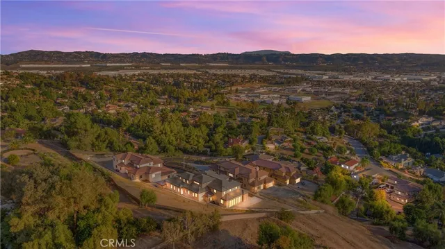 a view of a hallway with entryway wooden floor and windows