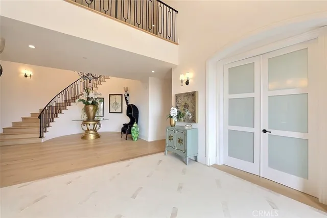 a living room with furniture a chandelier and a fireplace