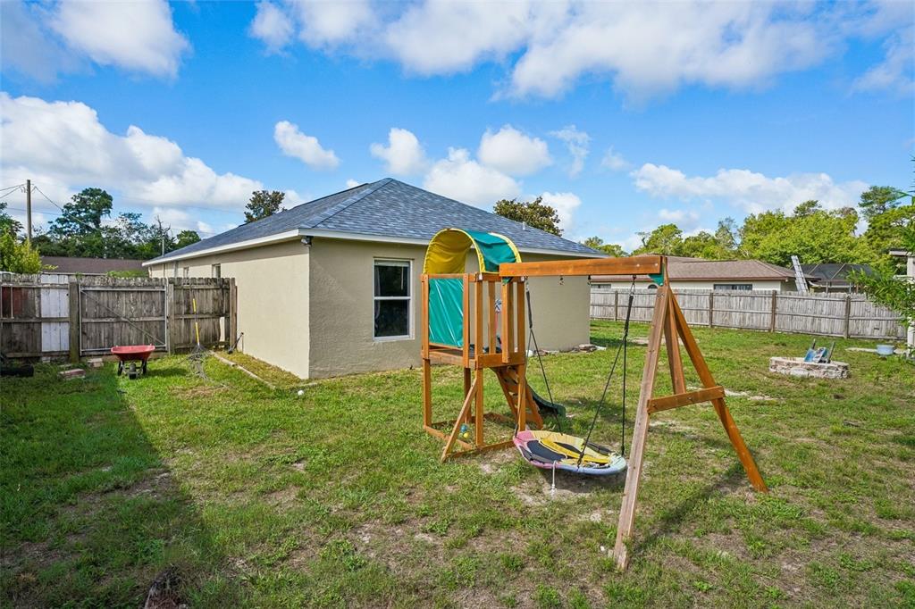 10303 Fordham Street Spring Hill, FL 34608 - Photo 24 of 25 a view of a house with a backyard