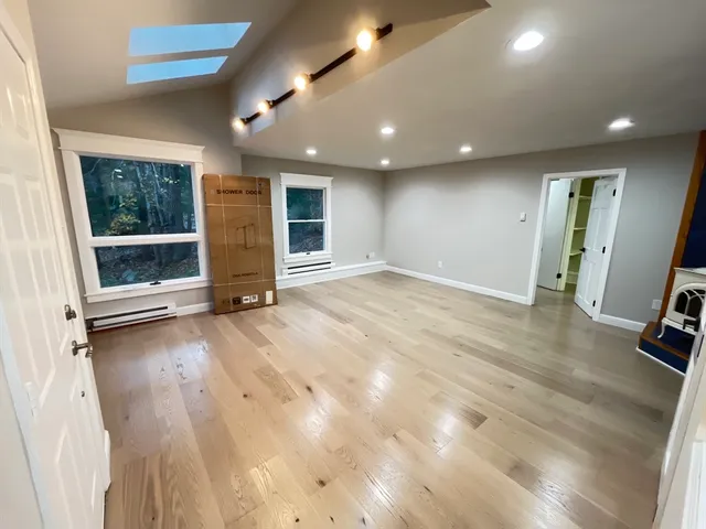 a kitchen with stainless steel appliances kitchen island granite countertop a stove refrigerator and microwave