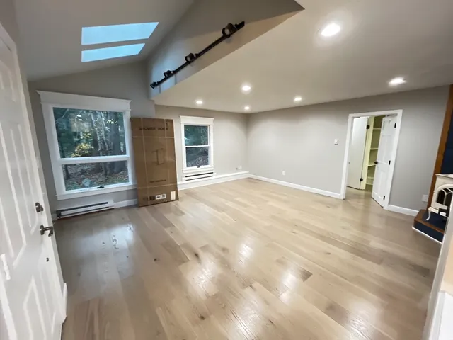a kitchen with a stove and a wooden floors