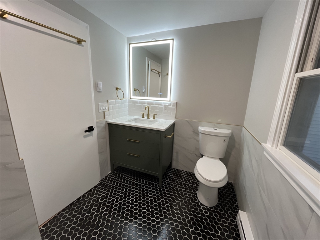 33 Highview Road Rockport, MA 01966 - Photo 8 of 31 a bathroom with a sink toilet a mirror and a shower