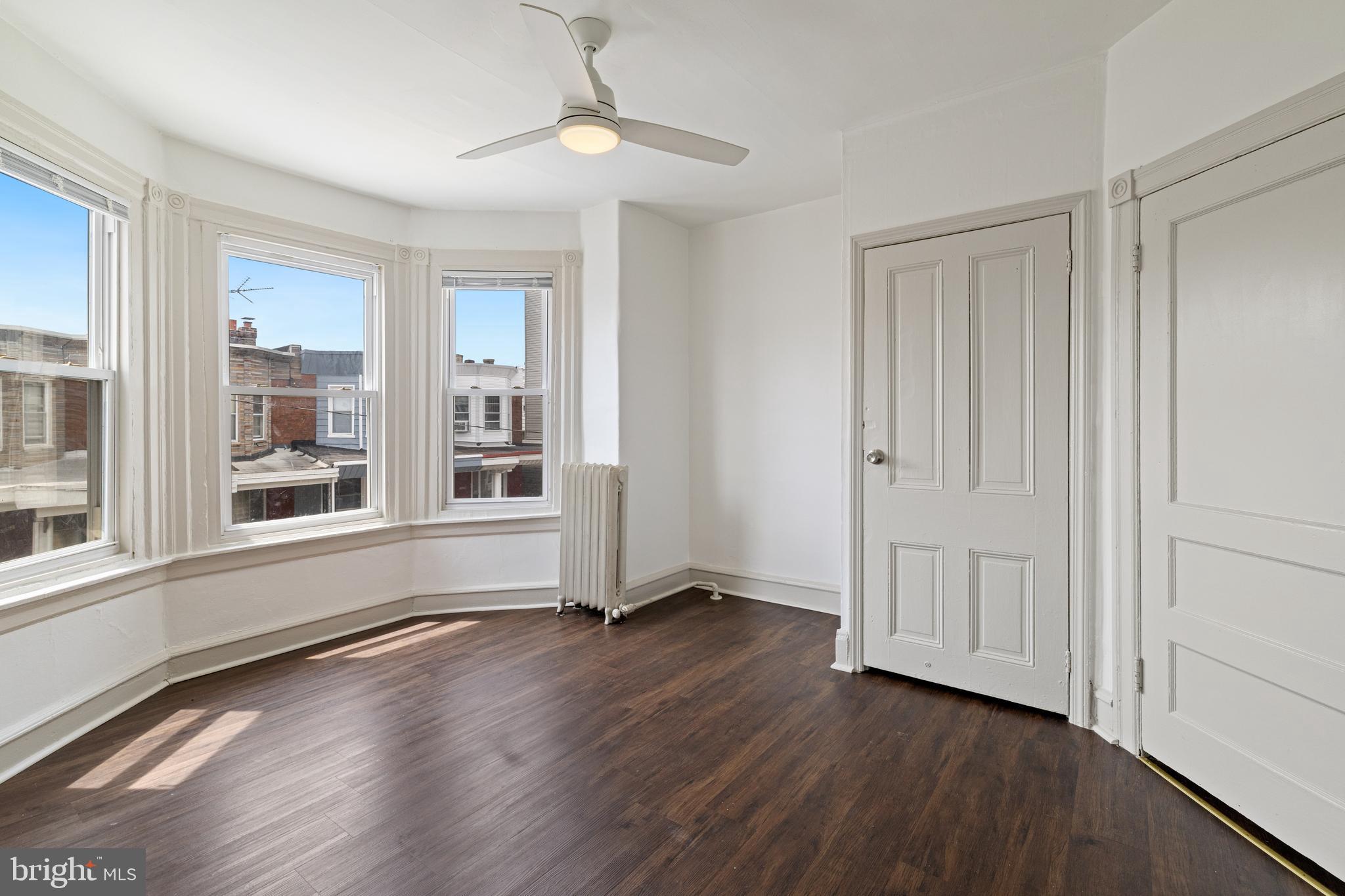 5551 Addison Street Philadelphia, PA 19143 - Photo 13 of 21 a view of an empty room with a window and wooden floor