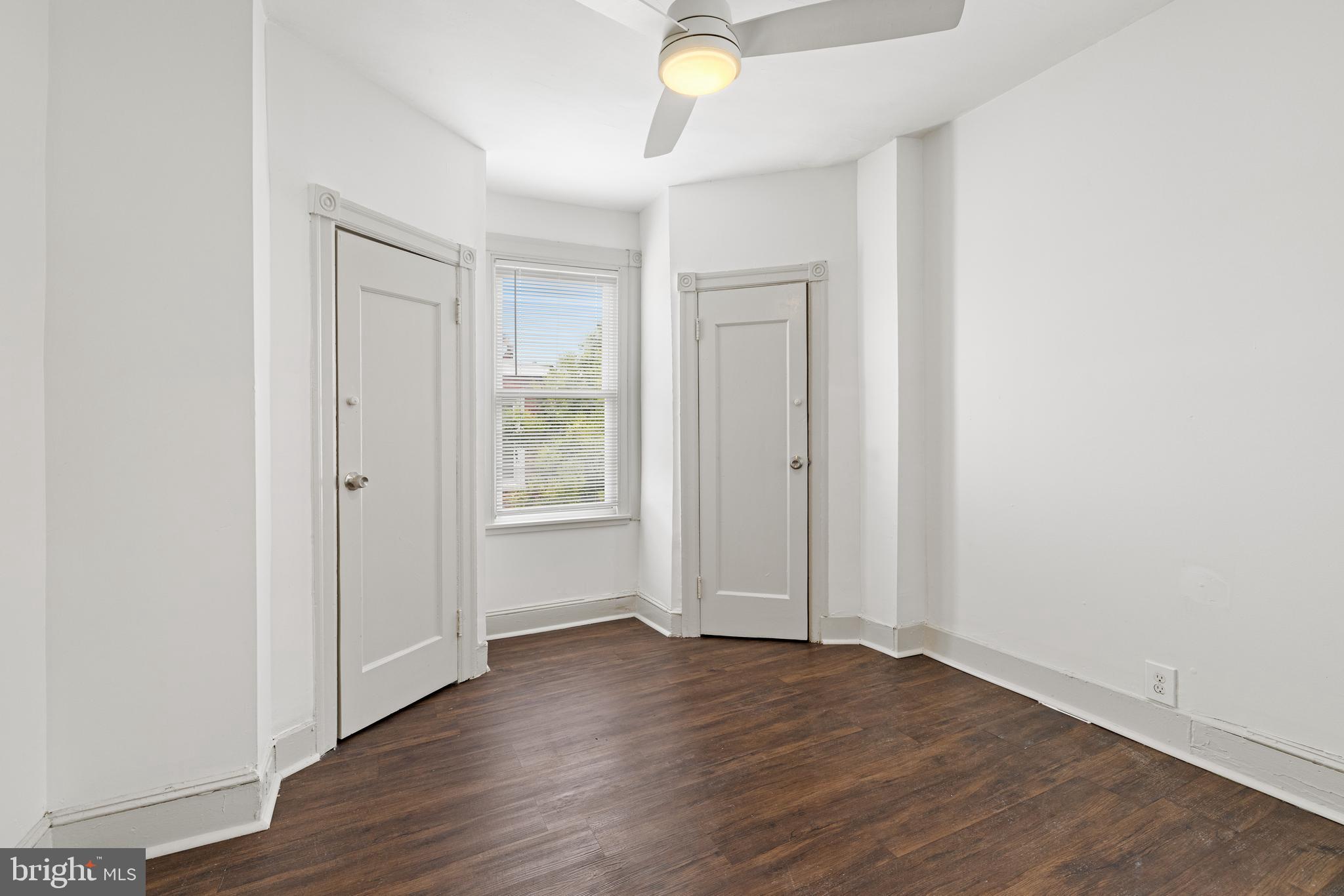 5551 Addison Street Philadelphia, PA 19143 - Photo 15 of 21 an empty room with wooden floor and windows