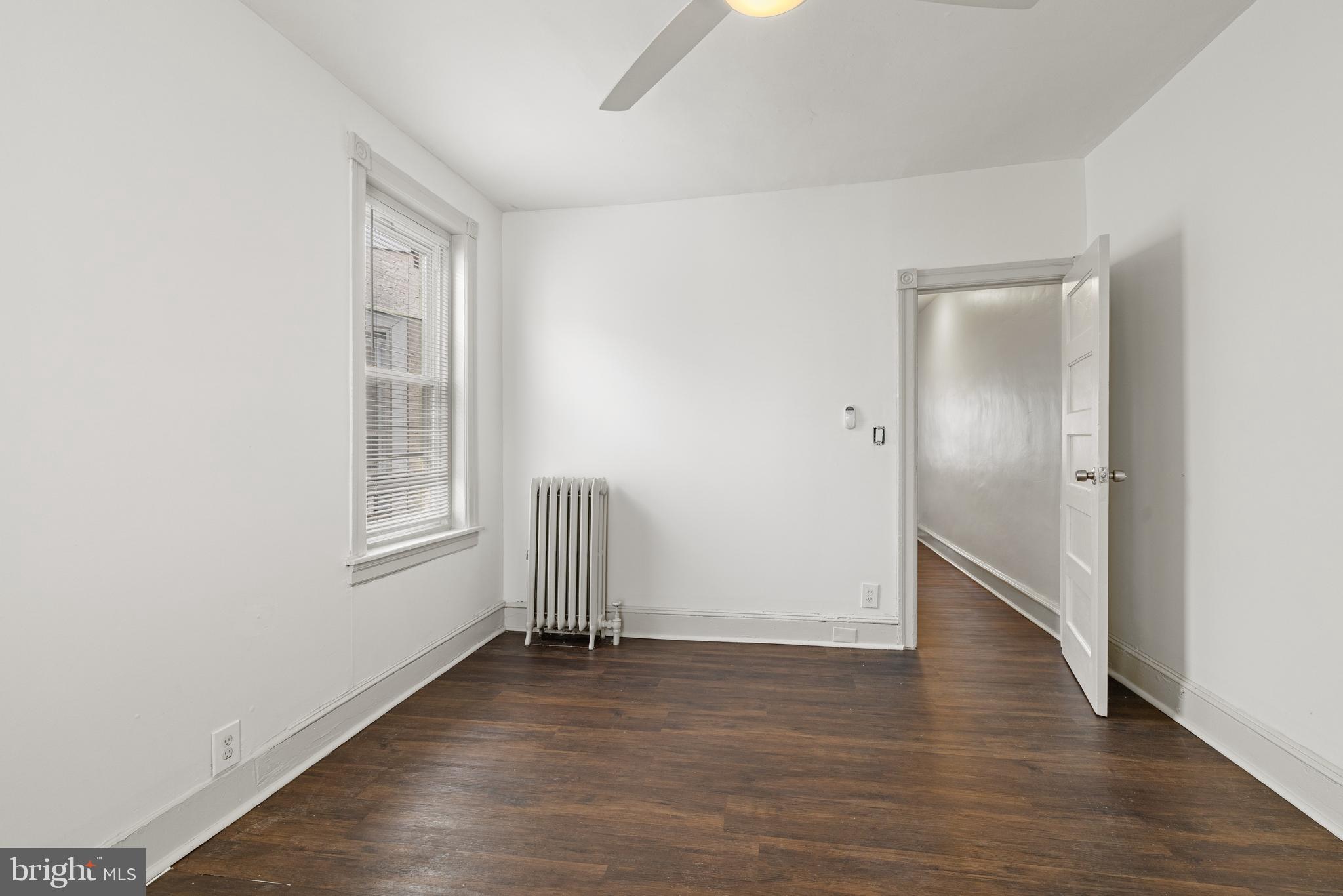 5551 Addison Street Philadelphia, PA 19143 - Photo 16 of 21 an empty room with wooden floor and windows