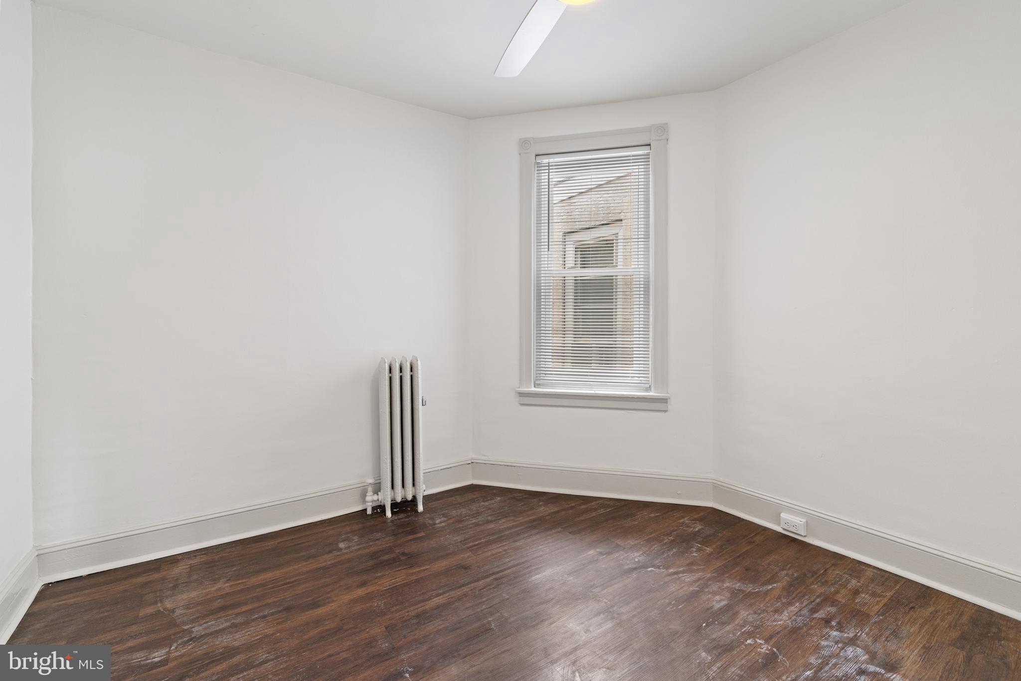 5551 Addison Street Philadelphia, PA 19143 - Photo 17 of 21 an empty room with wooden floor and window