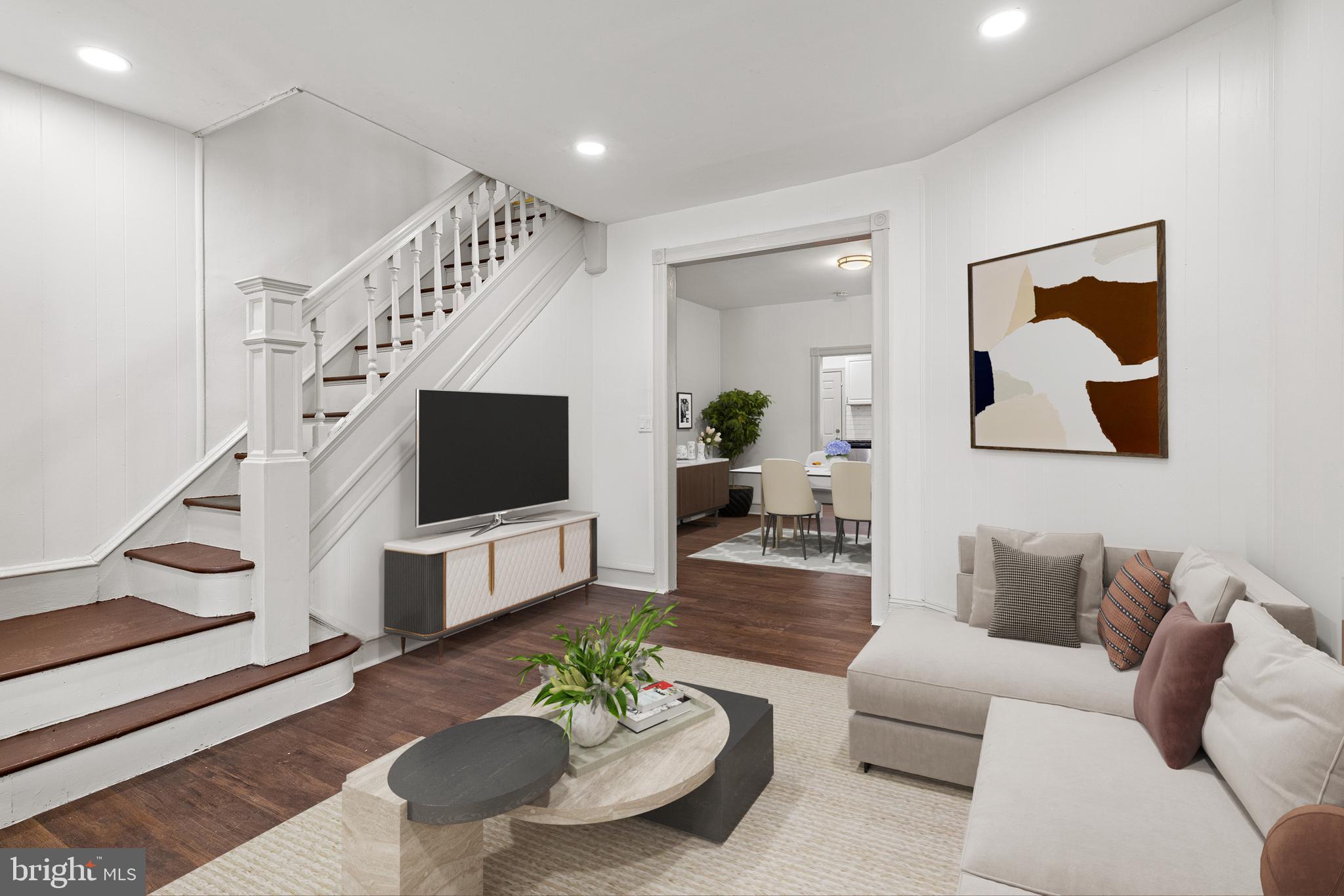 5551 Addison Street Philadelphia, PA 19143 - Photo 2 of 21 a living room with furniture and a flat screen tv