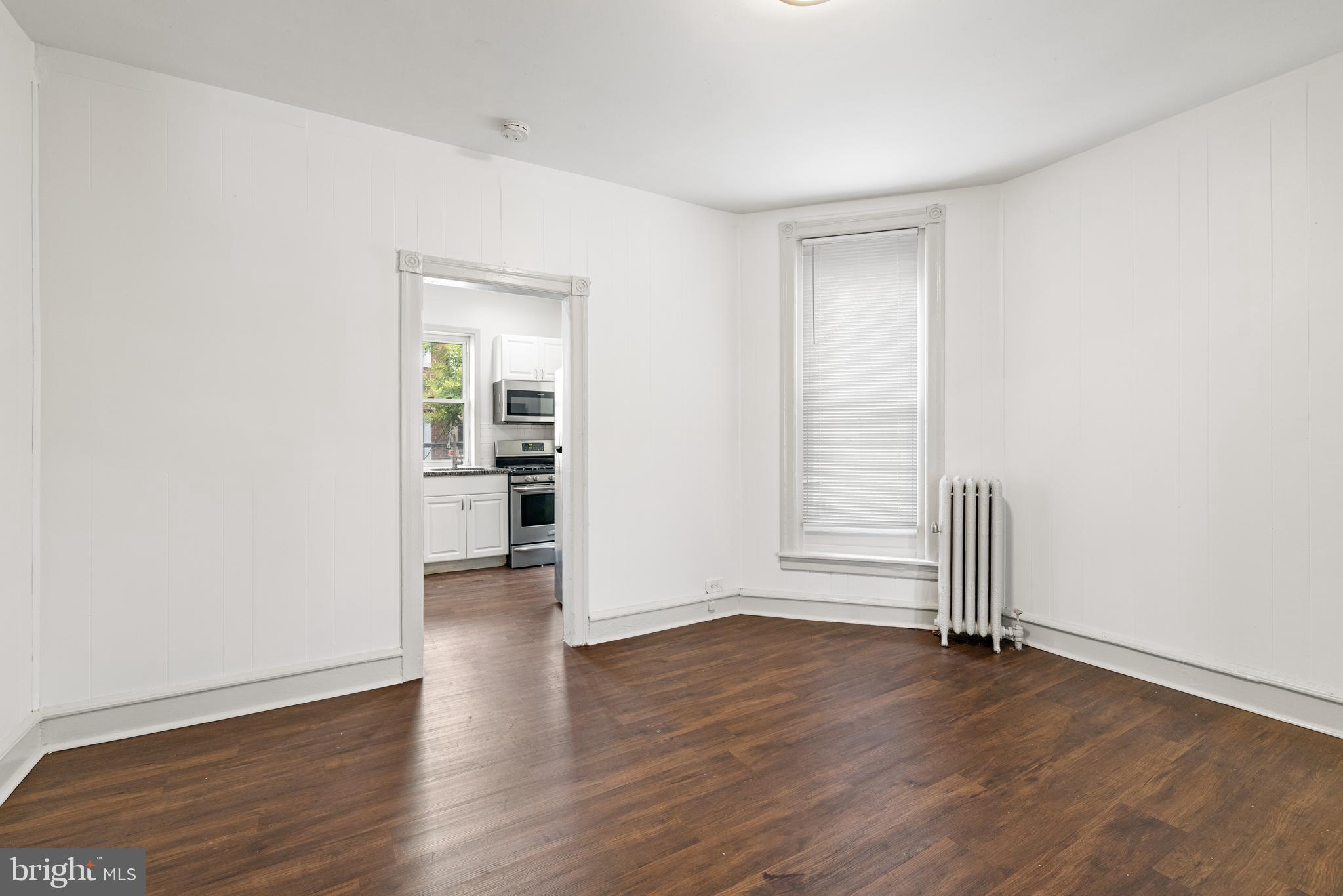 5551 Addison Street Philadelphia, PA 19143 - Photo 7 of 21 an empty room with wooden floor and windows