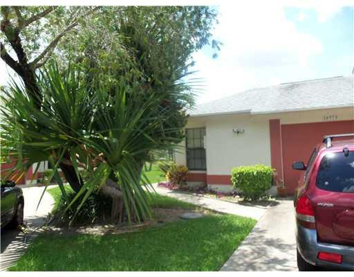 20973 Boca Ridge Drive West Boca Raton, FL 33428 - Photo 1 of 16 a view of a backyard with plants and a fire pit