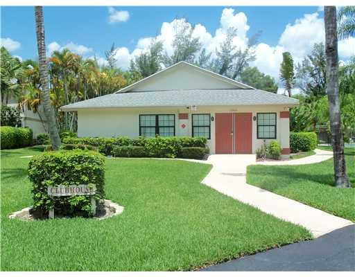 20973 Boca Ridge Drive West Boca Raton, FL 33428 - Photo 15 of 16 a front view of a house with a garden and plants