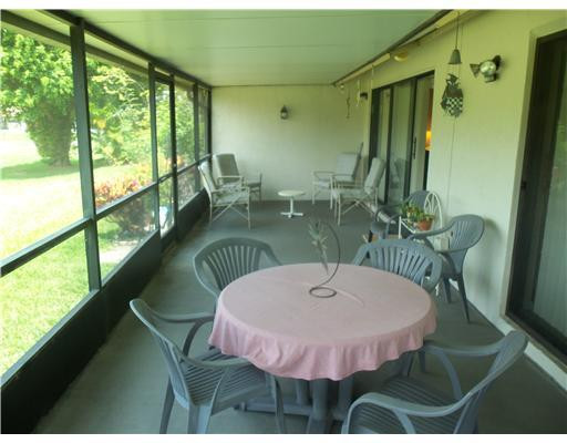 20973 Boca Ridge Drive West Boca Raton, FL 33428 - Photo 10 of 16 a table with table and chairs