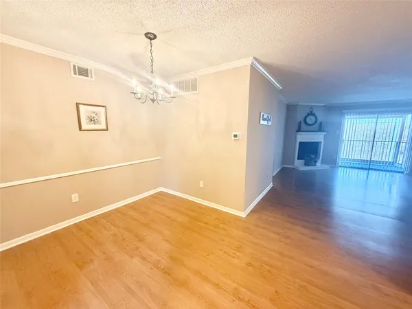 a kitchen with granite countertop a sink and a stove top oven with wooden floor