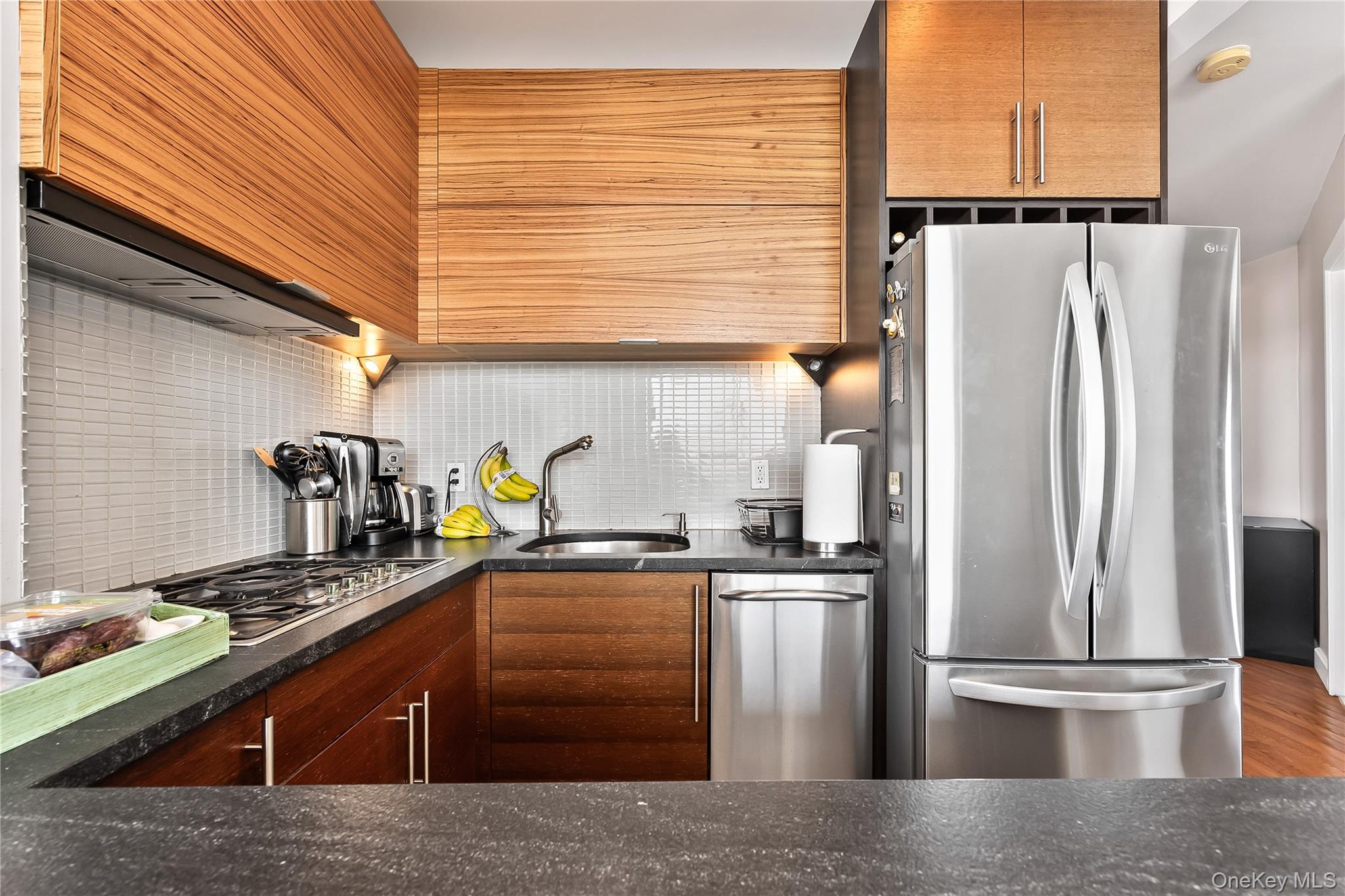 11-24 31st Avenue, Unit 12A Queens, NY 11106 - Photo 12 of 36 a kitchen with stainless steel appliances granite countertop a refrigerator a sink and a stove