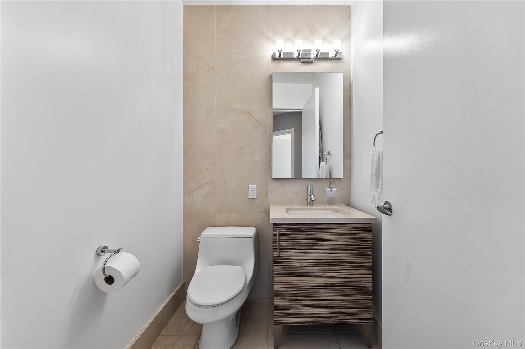 11-24 31st Avenue, Unit 12A Queens, NY 11106 - Photo 14 of 36 a bathroom with a toilet sink and mirror