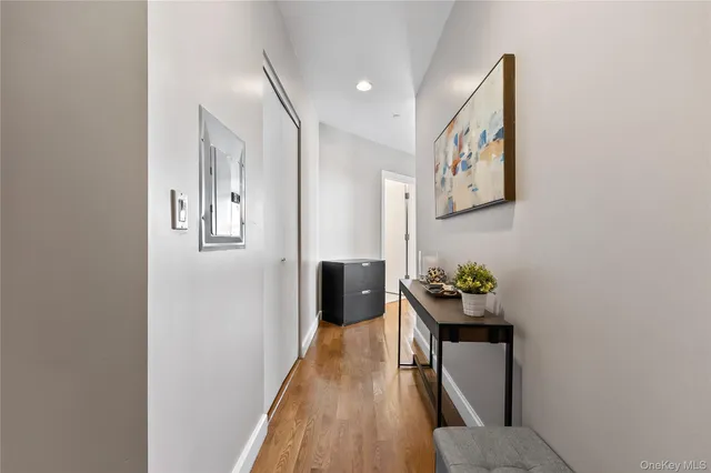 a hallway with furniture and wooden floor