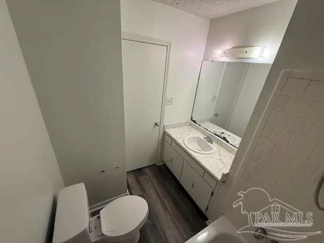 a bathroom with a sink a toilet and mirror