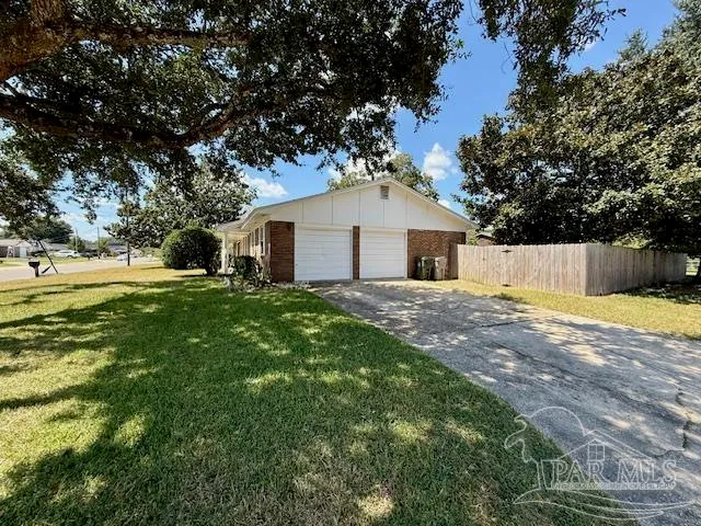 a view of a house with a backyard