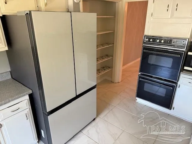 a kitchen with metallic refrigerator and stove