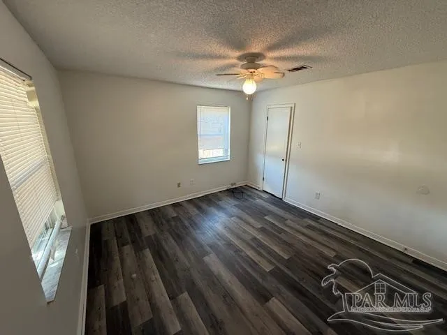 a view of an empty room and wooden floor
